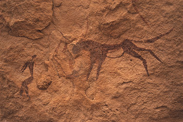 Felszeichnung mit Person und Rind